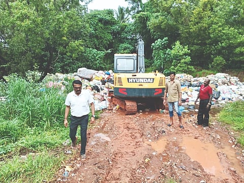  ಕಂಚಿನಡ್ಕ ಪದವಿನಲ್ಲಿರುವ ಪುರಸಭೆಯ ತ್ಯಾಜ್ಯ ವಿಲೇವಾರಿ ಘಟಕದಲ್ಲಿ ಕಾರ್ಯನಿರತ ಹಿಟಾಚಿ ಯಂತ್ರ.  