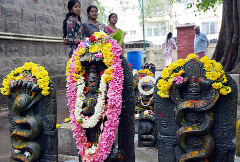 Devotees offered prayers by pouring milk on Nagarakallu at the Rameshwaram temple in Chamarajpet on Monday.