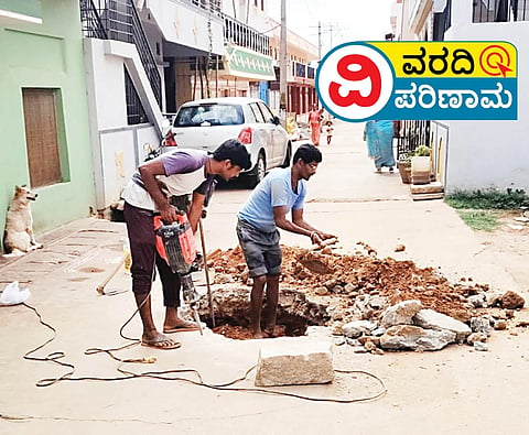 Municipality repairs manhole pit.