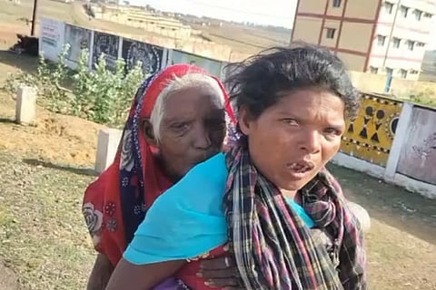  Woman carries mother in law on back