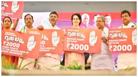 ಗೃಹಲಕ್ಷ್ಮಿ ಯೋಜನೆಯನ್ನು ಸಿದ್ದರಾಮಯ್ಯ, ಪ್ರಿಯಾಂಕಾ ಗಾಂಧಿ, ಡಿ.ಕೆ.ಶಿವಕುಮಾರ್ ಮತ್ತಿತರರು ಘೋಷಣೆ ಮಾಡಿದ ಸಂದರ್ಭ.