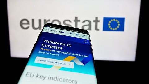 Mobile phone with website of EU institution European Statistical Office Eurostat in front of logo. 