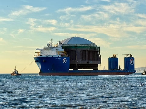 The tank is made of steel, closed at the top and open at the bottom with a net.