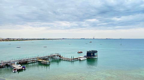 View of the Caspian Sea from Cape Melovoy in Aktau, Kazakhstan. A small wooden pier with boats moored to the water.