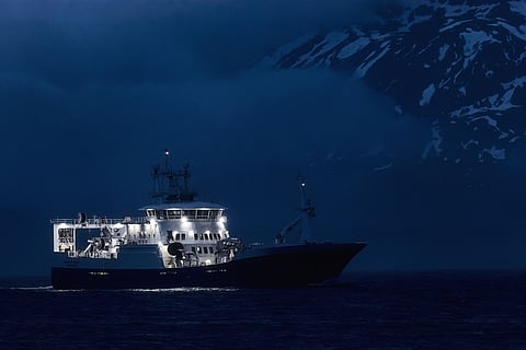 A commercial fishing vessel operating at night in Iceland.  