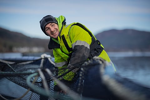 A worker in a salmon farm in Scotland. 