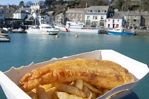 Fish and chips at Padstow harbour in Cornwall, UK.
