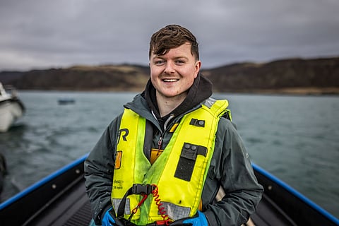 Worker at a salmon farm in Scotland.