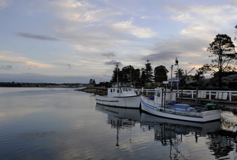 Two fishing boats in the evening anchored at Greenwell Point a township located on the Crookhaven River in the Shoalhaven area, New South Wales.