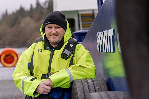 Ian Laister, Managing Director at Bakkafrost Scotland, poses aboard the Spirit of Bute, a landing craft built by Bute Boat Builders.