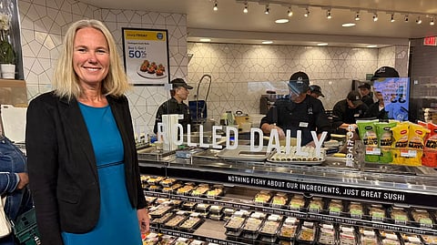 Norwgian seafood envoy to the USA, Karine Rød Haraldsson, pictured alongside a sushi counter.