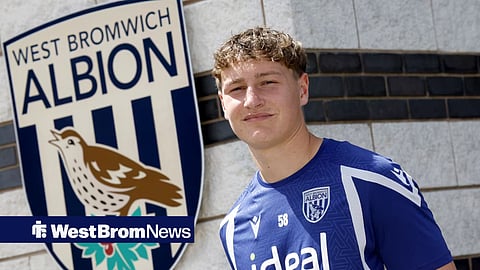Will Rutter stood next to a giant West Brom badge