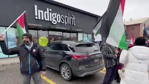 Pro-Palestine demonstrators outside an Indigo Spirit book store in Oakville, Ontario. 