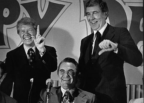 Soon-to-be president Jimmy Carter skidding around with George Wallace (seated) and fellow Democrat Morris Udall at a campaign stop in Detroit during the 1976 presidential election. Columnist Michael Wagner scratches his head over how the late president's biographers have allowed Carter's dogwhistles to segregationist voters to be overlooked