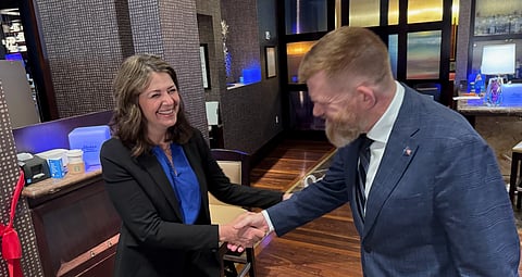 Danielle Smith greats Brian Jean in Houston