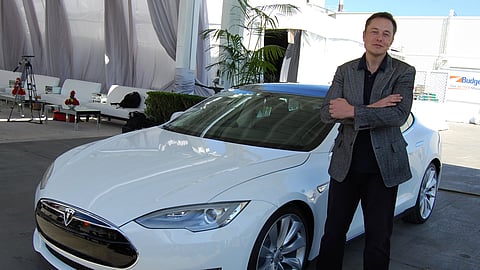 Elon Musk with a Tesla vehicle