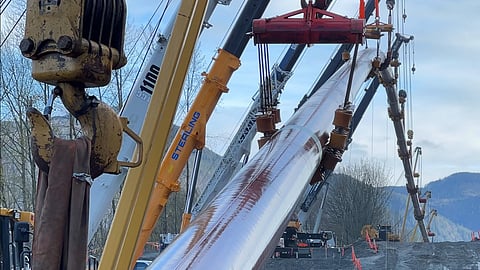 Welding a section of the TMX, near Hope