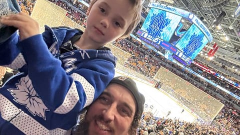 Evan Blackman at a hockey game with his son Damian