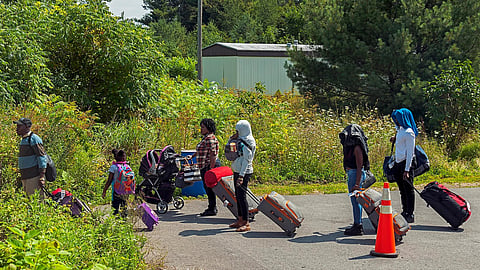 Asylum seekers preparing to cross the US-Canadian border from the end of Roxham Road in Champlain, NY. 