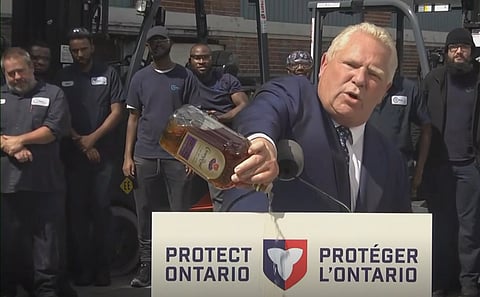Ontario Premier Doug Ford pours bottle of Crown Royal out on ground
