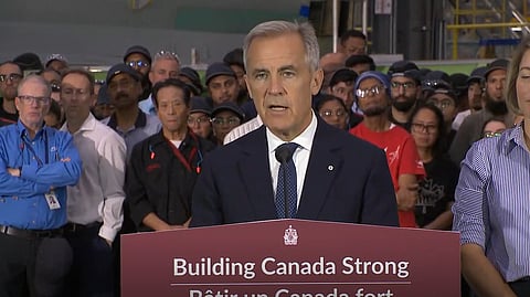 Prime Minister Mark Carney speaks to reporters