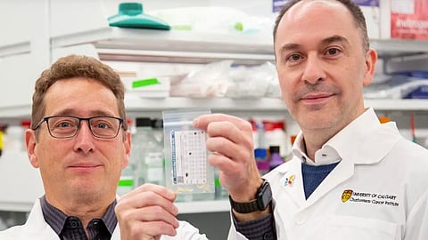 Michael Weiser, left, and Aaron Goodarzi hold one of the toenail clipping collection bags.
