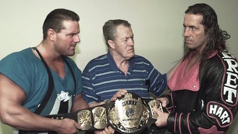 Stu Hart, centre, with his son Bret, right, and the British Bulldog, left