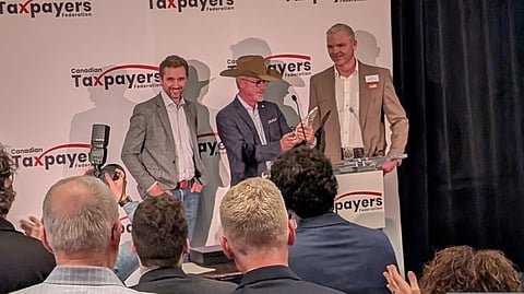 Brad Wall receives the Canadian Taxpayers Federation's Tax Fighter Award flanked by CTF president Scott Hennig (L) and CTF board chair and former Wall cabinet minister Tim McMillan (R)