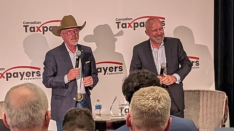 Former Saskatchewan premier Brad Wall stands by former radio host John Gormley at the Hotel Saskatchewan in Regina, Oct. 16, 2025