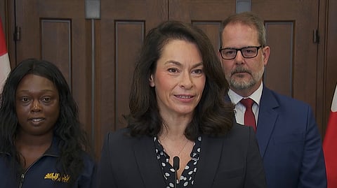 Heather McPherson speaking to reporters in Ottawa