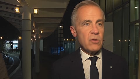 Mark Carney speaking to reporters in Asia