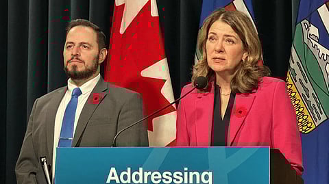 Premier Danielle Smith flanked by Education Minister Demetrios Nicolaides at press conference in Calgary on Friday. 