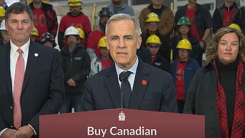 PM Mark Carney speaking to reporters in Fredericton NB