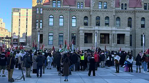 Hundreds of individuals gather for a Palestinian flag raising outside of Calgary's City Hall. 