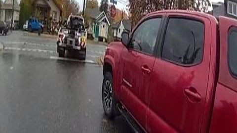 A red pickup truck is about to be towed away after its driver was stopped for impaired driving while leaving traffic court