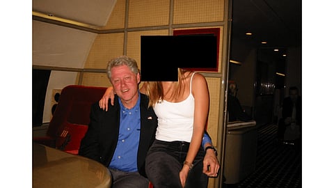 Bill Clinton with a woman whose face has been redacted. 