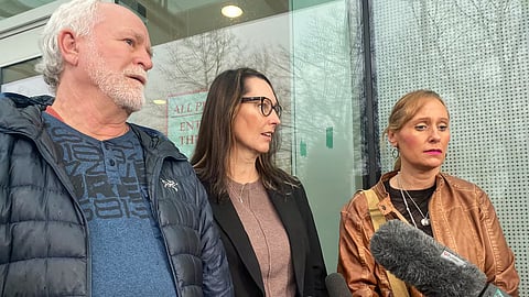 Daughters of the victims, Sandra (centre) and Kimberly (right), speak to reporters during a break in the trail of the three men accused of the murder of their parents on Jan. 12th 2026