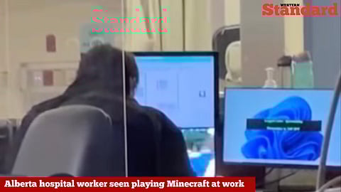 A screenshot from a video showing an Alberta hospital worker who appears to be playing Minecraft while on the job. 