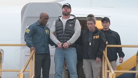 Ryan Wedding, in cuffs, arrives back in California under arrest by the FBI