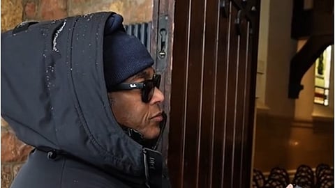 Don Lemon conducting an interview outside of the church with a member of the congregation 