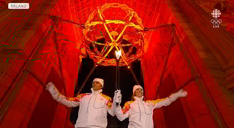 Deborah Compagnoni and Alberto Tomba light the Olympic flame in Milan