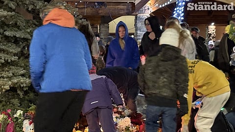Tumbler Ridge residents placing candles at a memorial for victims of Tuesday's shooting. 