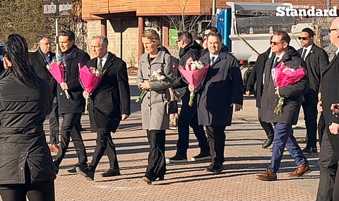 Mark Carney, Pierre Poilievre, and Yves-François Blanchet walking with flowers to place in front of the Tumbler Ridge shooting memorial. 