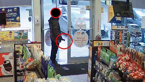 Man holding Taser exits store