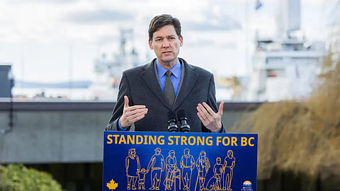 BC Premier David Eby stands in front of a Canadian Coast Guard station at Victoria to promote a new $400 million “strategic investment fund” to subsidize shipbuilding and other industrial and defence projects, February 25, 2026.