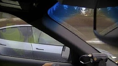 A screenshot of police video that showed a driver who appeared to be asleep at the wheel of an electric vehicle during rush-hour traffic