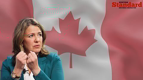 Danielle Smith in front of a Canadian flag. 