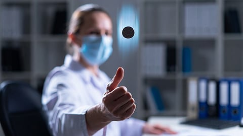 doctor flipping coin