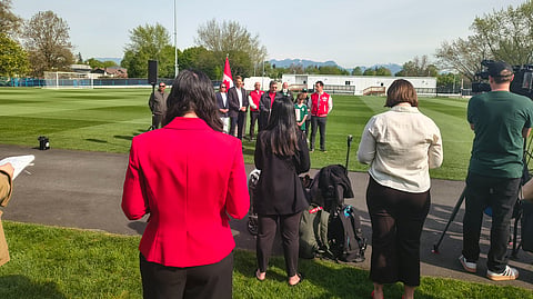 Liberal MPs Gregor Robertson and Adam van Koeverden announce a record $750-million federal investment in Canadian sports at a Vancouver-area sports field on May 1, 2026. The event came as both federal and B.C. governments face record-high deficits, with questions also raised about the future of the Vancouver Whitecaps MLS team.