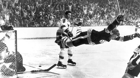 The moment after Bobby Orr scored the winning goal when the Bruins defeated the St Louis Blues, in the 1970 Stanley Cup final.